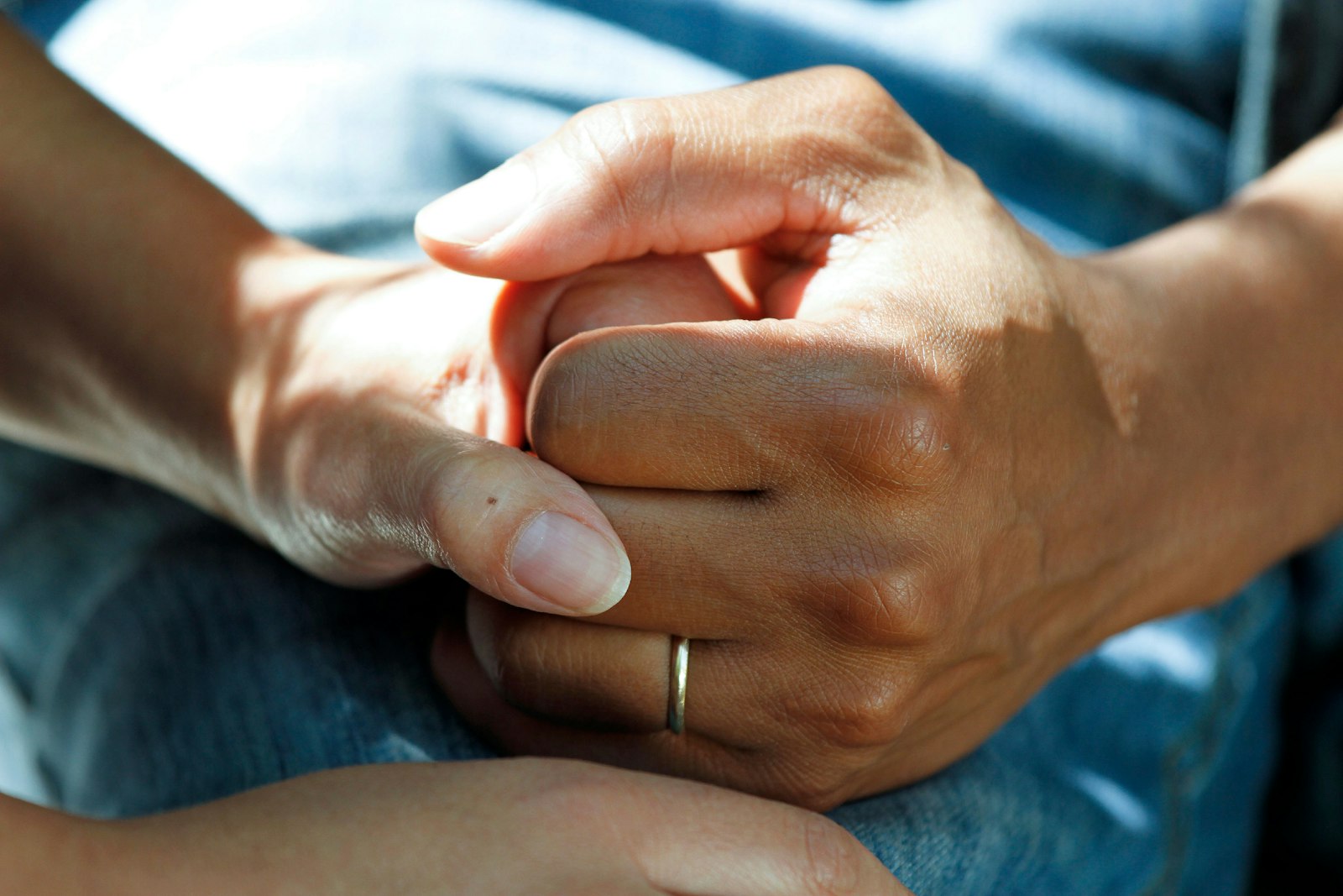A parent holding a child’s hand during a paediatric consultation